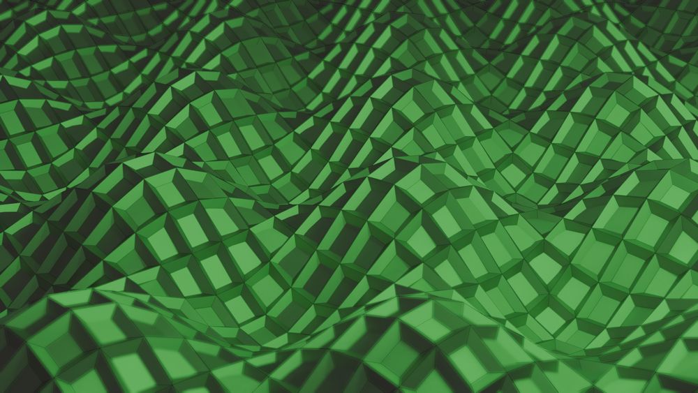 An abstract image made in Blender, showing a series of stylized "rolling hills" that were created by superimposing sine and cosine waves across a tiled, green plane. The edges of each tile are slightly raised. There is also some depth of field, with the middle of the image being sharper than the slightly blurrier areas at the top and bottom.