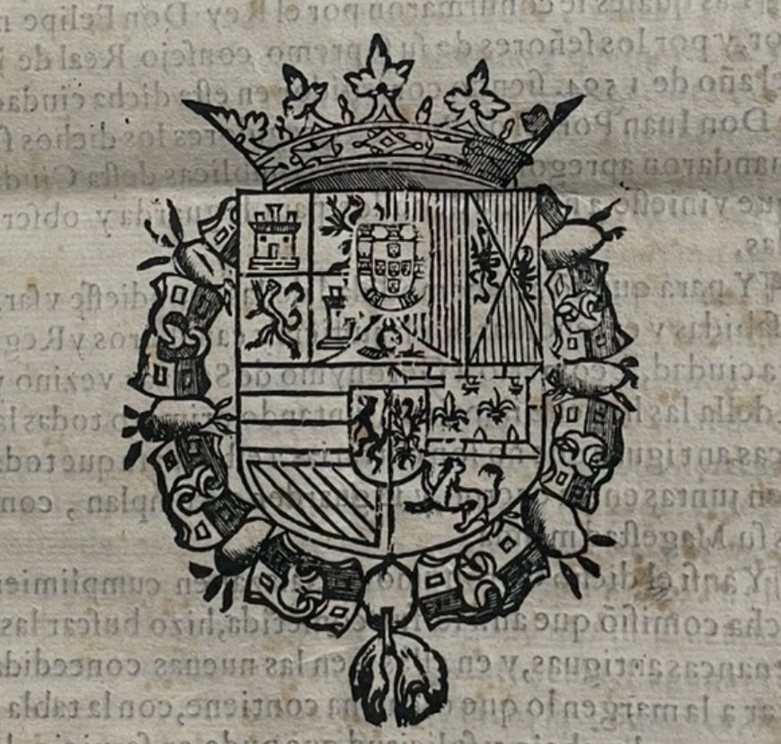 Coat of arms of Spain imprinted in 1580 volume - quadrants with griffins, stripes, small shields in center of upper and lower parts. Ringed around with crown on top. Ink from next page faintly showing through. 