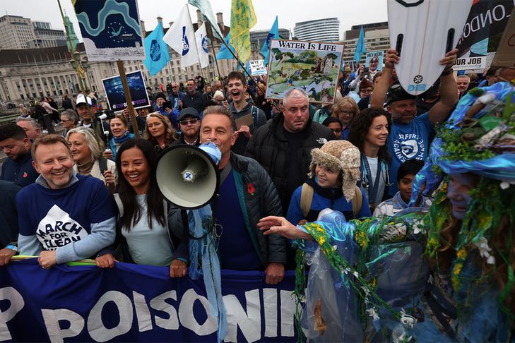 The naturalist and television presenter Chris Packham, centre, leads a protest during a clean water march in central London.
