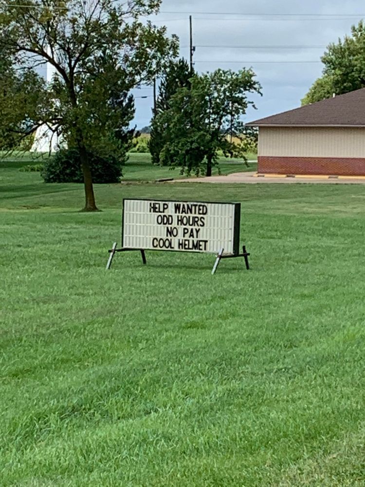 Help wanted sign joke about no pay but cool helmets