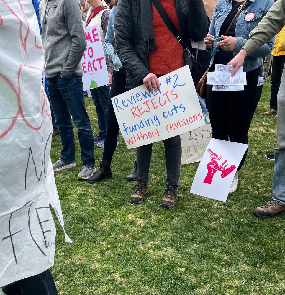 Sign that says "Reviewer #2 rejects funding cuts without revision"