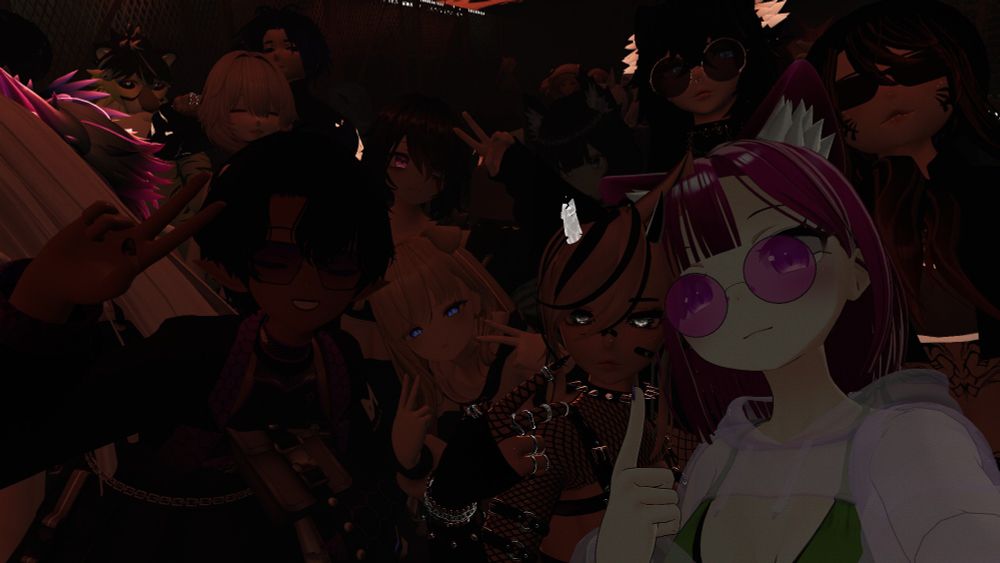 My avatar together with a bunch of friends avatars posing for the camera in the middle of a dark and crowded club