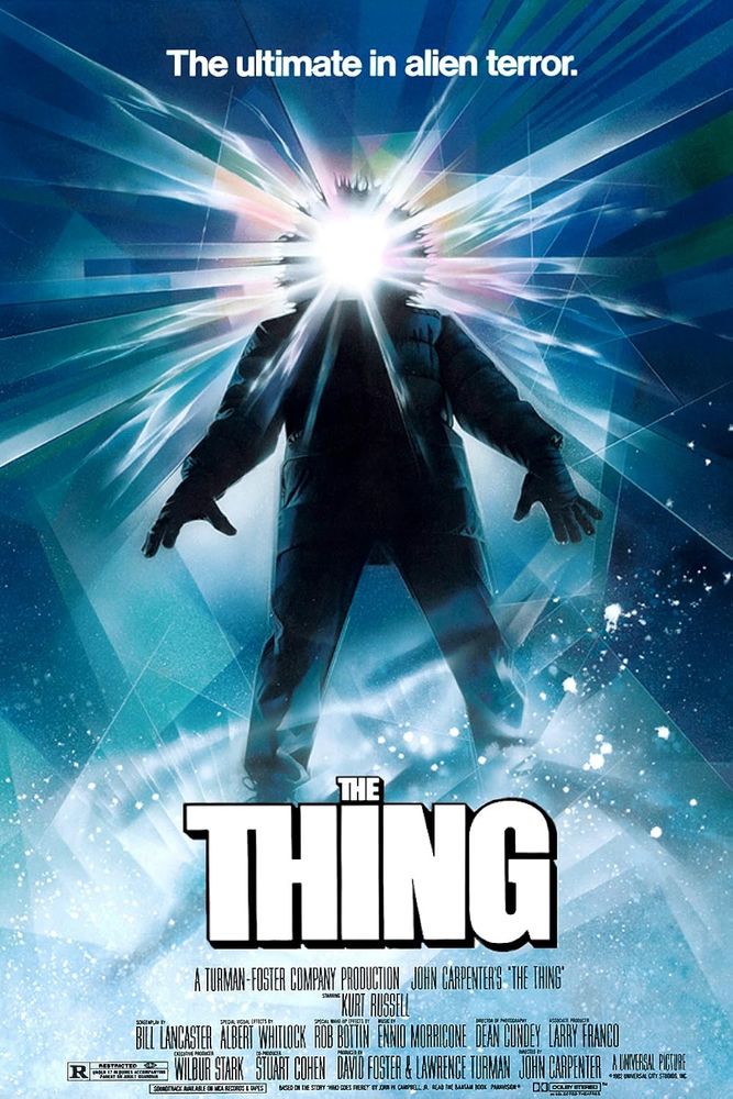 Movie poster for The Thing. A blue background with snow at the bottom, a man dressed in winter coat is standing over title. 