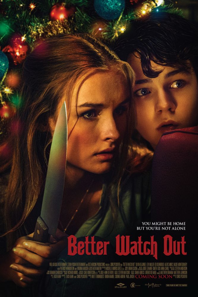 Movie poster for Better Watch Out. Blonde girl and younger boy are crouching behind Christmas tree with lights, the girl is holding a knife. 