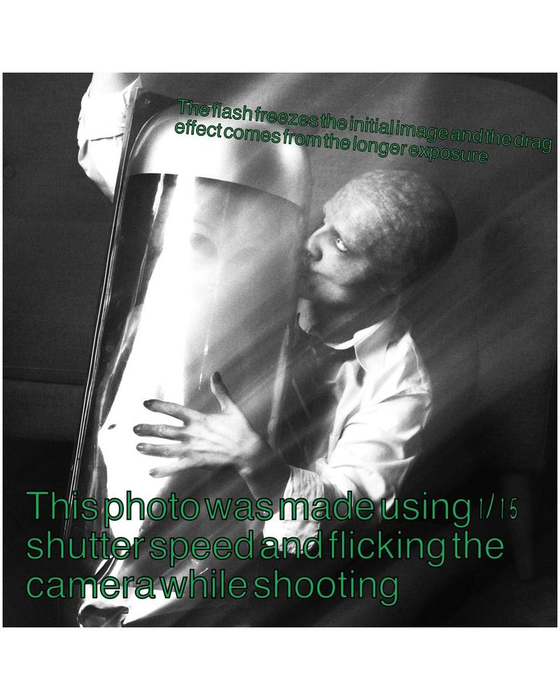 A black and white smeared exposure of an alien-person holding a capsule with a tiny alien inside
Text "This photo was made using 1/15 shutter speed and flicking the camera while shooting. The flash freezes the initial image and the drag effect comes from the longer exposure"