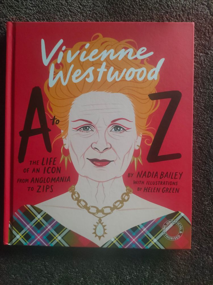 A to Z if Vivian Westwood book. Red book with drawing of woman with red hair in a tartan top