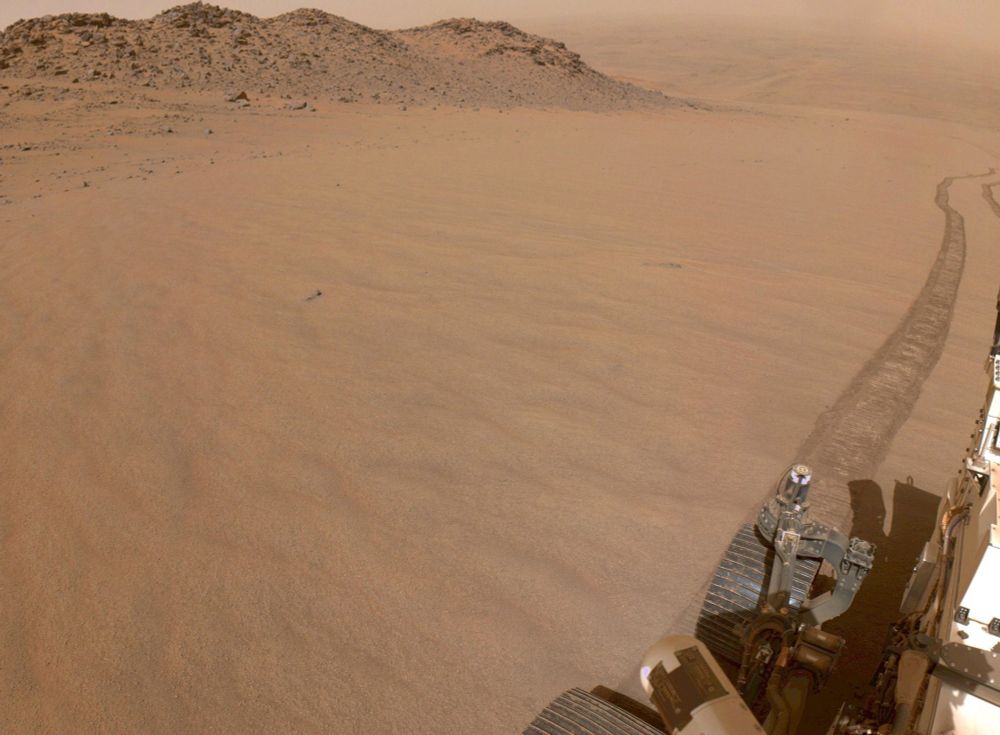 A picture of the surface of Mars from the rover looking down into the crater.