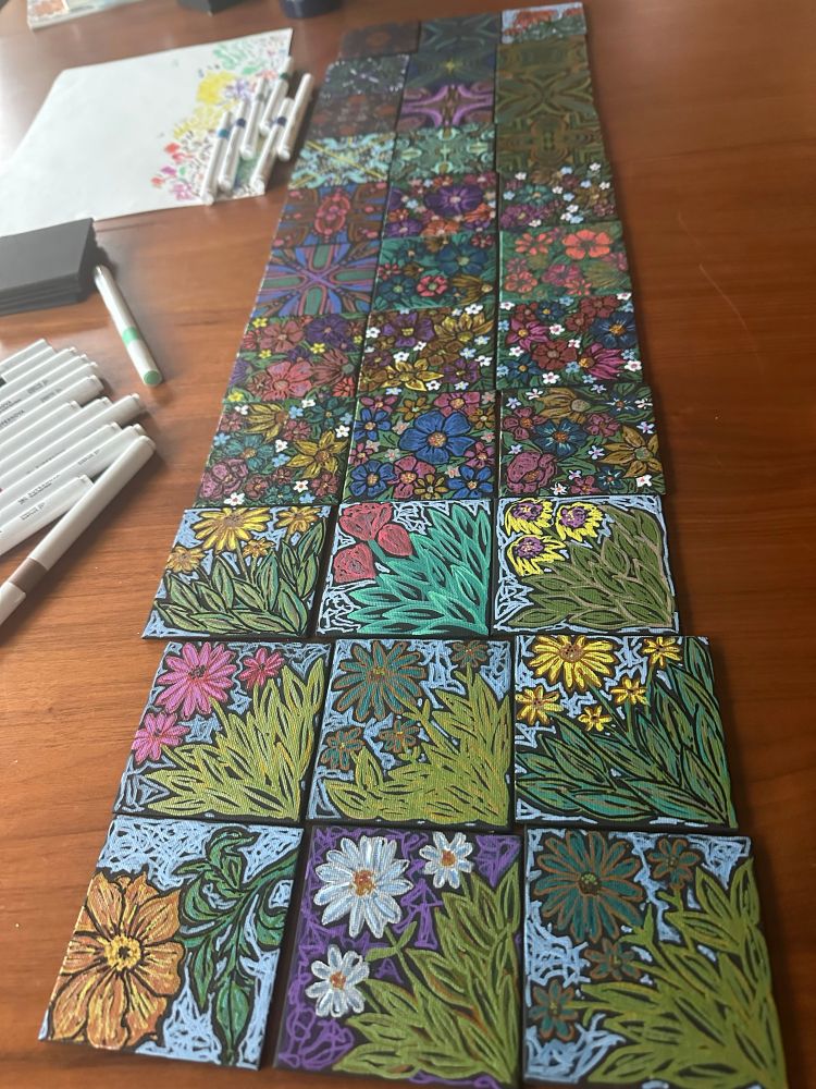 33 small canvases with marker drawings of flowers and patterns. 