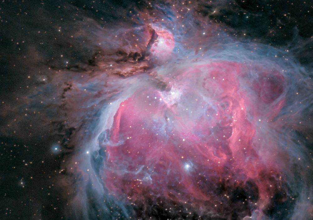 A false color image of the actual Orion nebula, where you can see many of the features from the illustration, but without the foldy fabric bands. 