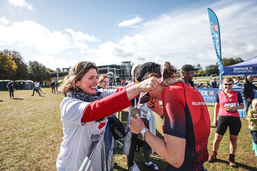 Person getting a medal at the Impetus Triathlon