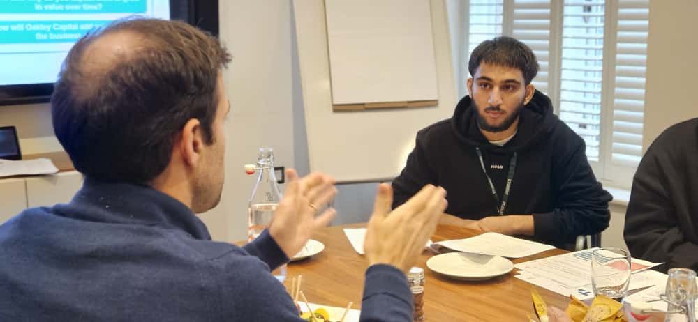 Young person listening to volunteer speaking.