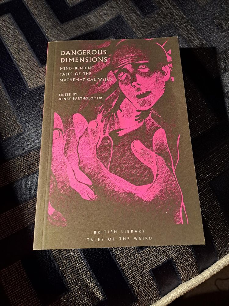 The cover of the book. 

The image is all in pink on a black background. A face above a hand which has all the wrong number of fingers, because there seem to be multiple versions of it overlapping but out of phase with each other. Shadow hands behind the head reach down towards their shoulder.