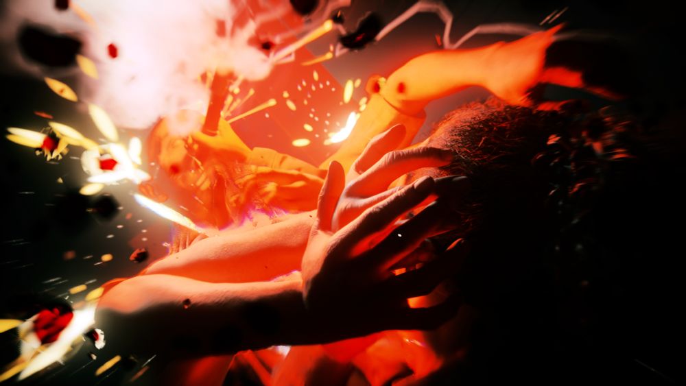 Virtual photography capture from Alan Wake 2. An enemy with many arms attacks Saga Anderson, with two right hands visibly grabbing her hands while a left hand hangs free. Saga is jamming a lit flare into the mouth of the Taken, giving the image a red glow along with white smoke and yellow sparks. The image is tilted to accentuate the action of the shot. The back of Saga's head is visible and the right hands of the monster are in focus with a gentle white light on them to make them appear more human in skin tone.