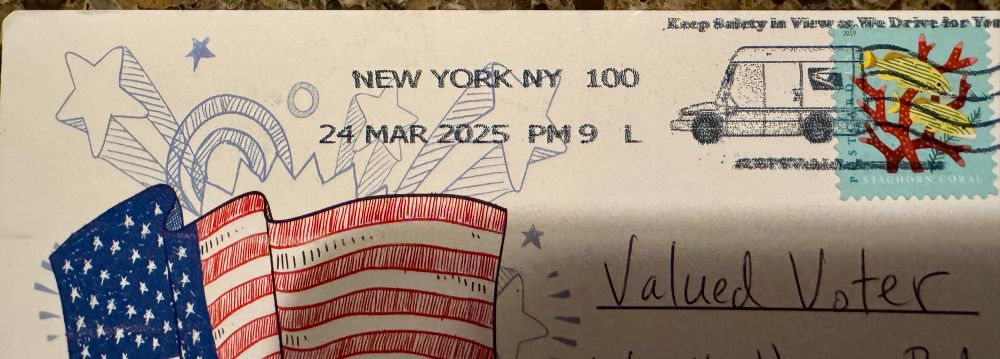 The top of the other side of the postcard. It is addressed to Valued Voter and was postmarked in New York, New York. There is an image if a waving American flag. 