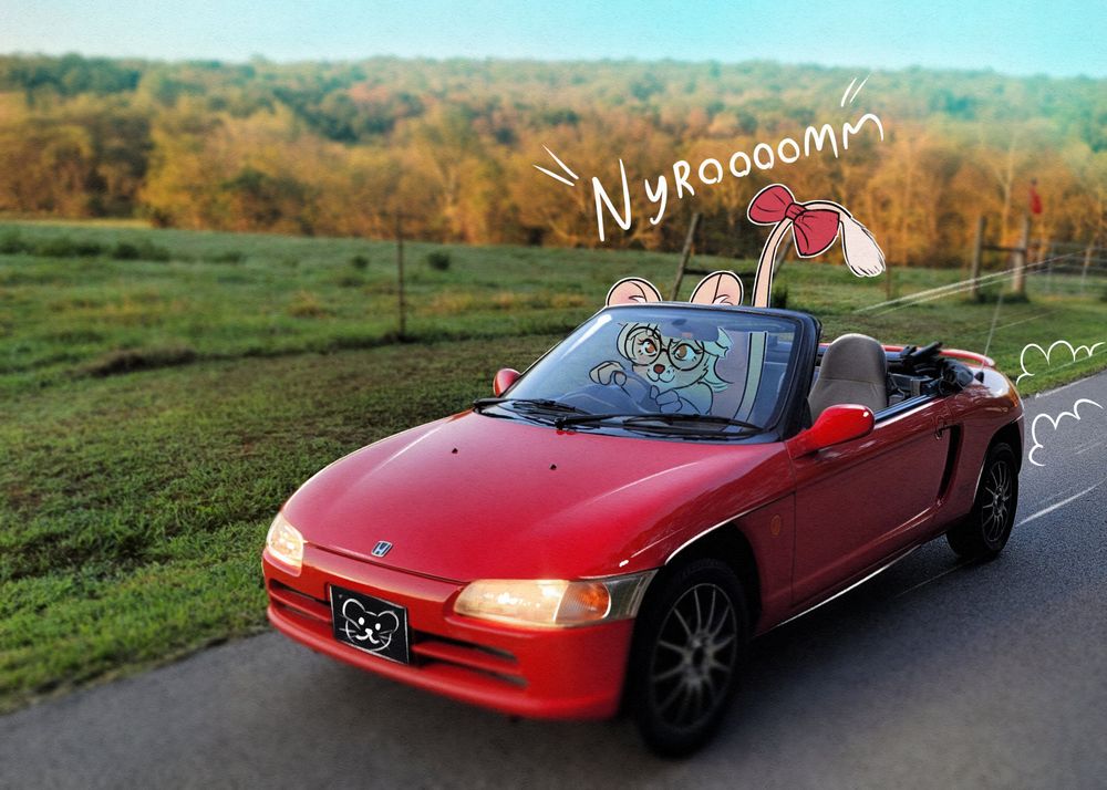 Image of a red Honda Beat, a small convertible car. A mouse character is drawn over the photo depicting him driving it.