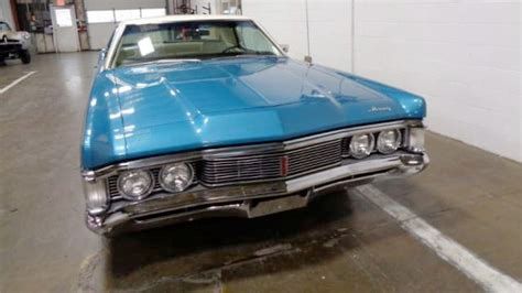front view of a 1969 Mercury Monterey in blue, with a white vinyl top