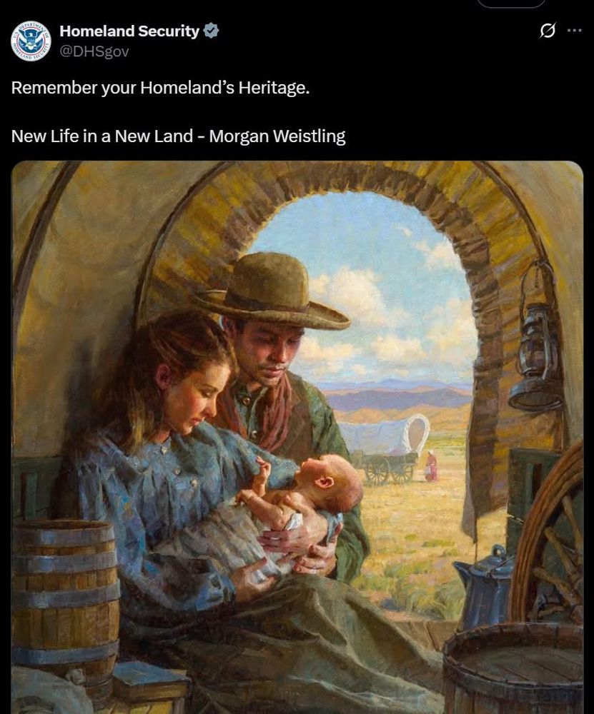 A romanticized painting titled New Life in a New Land by Morgan Weistling, depicting a young white pioneer family inside a covered wagon. The mother cradles a newborn baby while the father, wearing a wide-brimmed hat, lovingly gazes at them. Outside the wagon, a bright landscape shows open plains, distant mountains, and another covered wagon in the background. The image is accompanied by a tweet from the U.S. Department of Homeland Security (@DHSgov) that reads: “Remember your Homeland’s Heritage. New Life in a New Land – Morgan Weistling.”