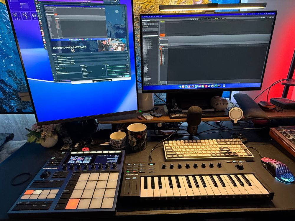 A dual monitor pc setup with a groovebox and keyboard ready to make some jams!