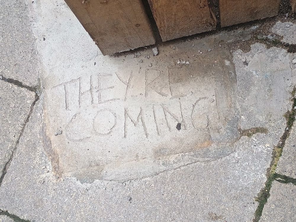 a patch of concrete with They're Coming written into it, an image taken in Salford on the last First Sunday July 2025
