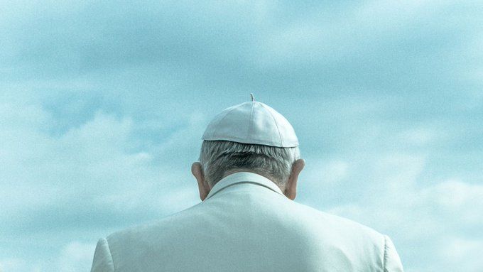 Photo of Pope Francis (1936-2025), with blue sky and clouds.