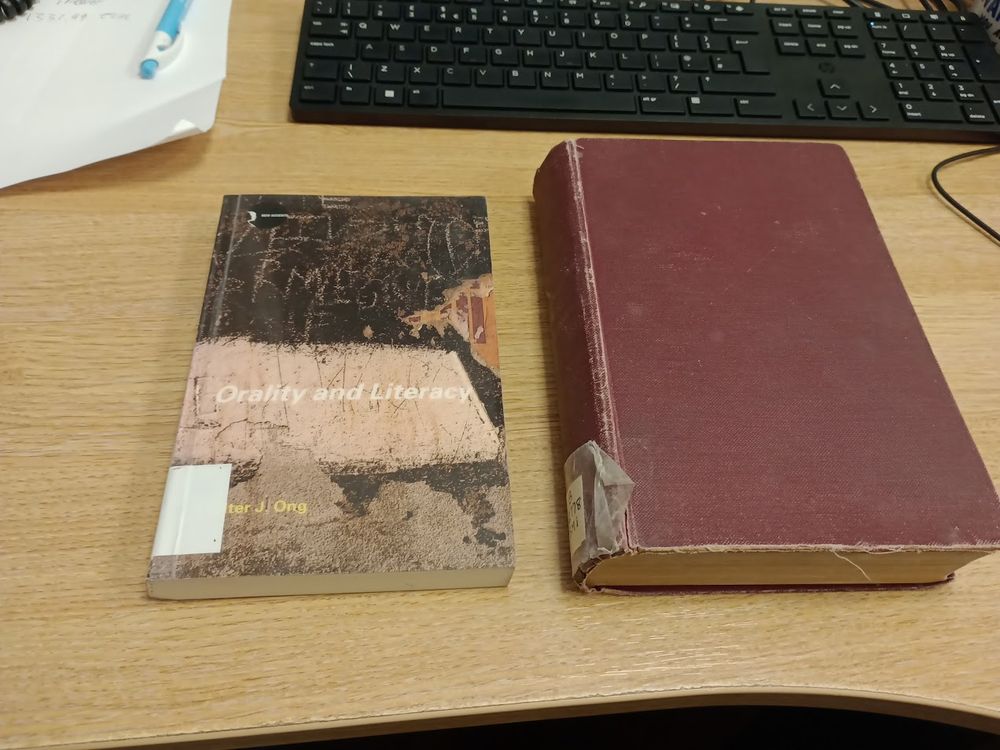 Two books on the Librarian's desk. One earlier and one later twentieth-century book.