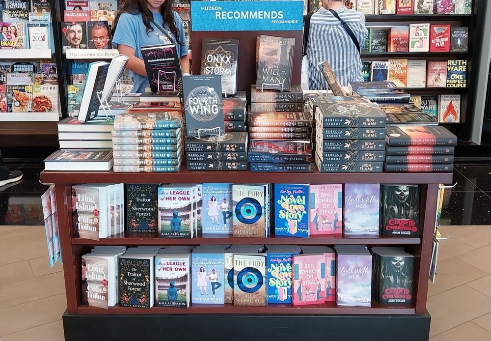 The Hudson Recommends shelf at YVR with books, including copies of THE TRAITOR OF SHERWOOD FOREST.