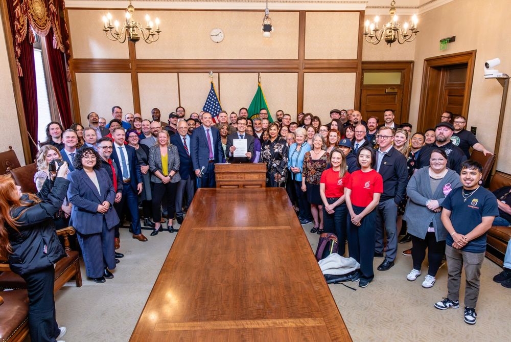 Dozens of Washington union members gathered in a conference room for the bill signing