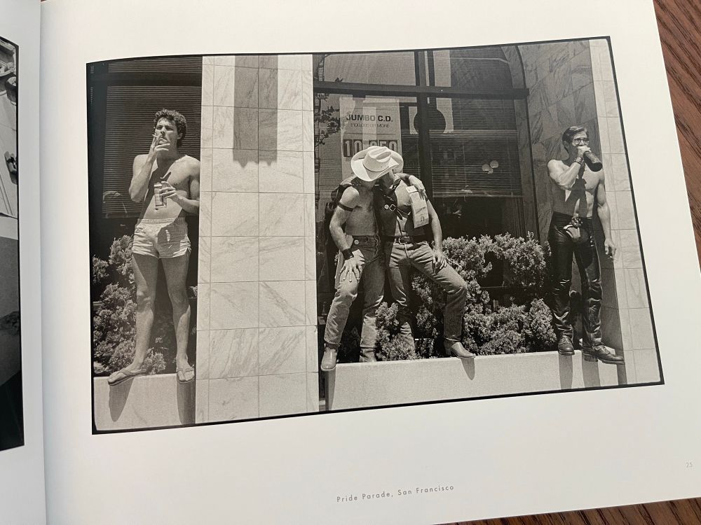 Two leather cowboys kiss during a Pride parade in SF 