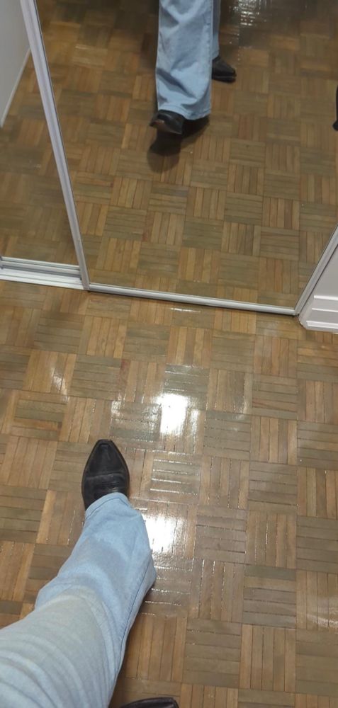 An image of his cowboy boots reflected in the mirror
