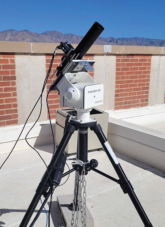 ULTRASIP, mounted on a tripod, set up on a rooftop with mountains in the background.