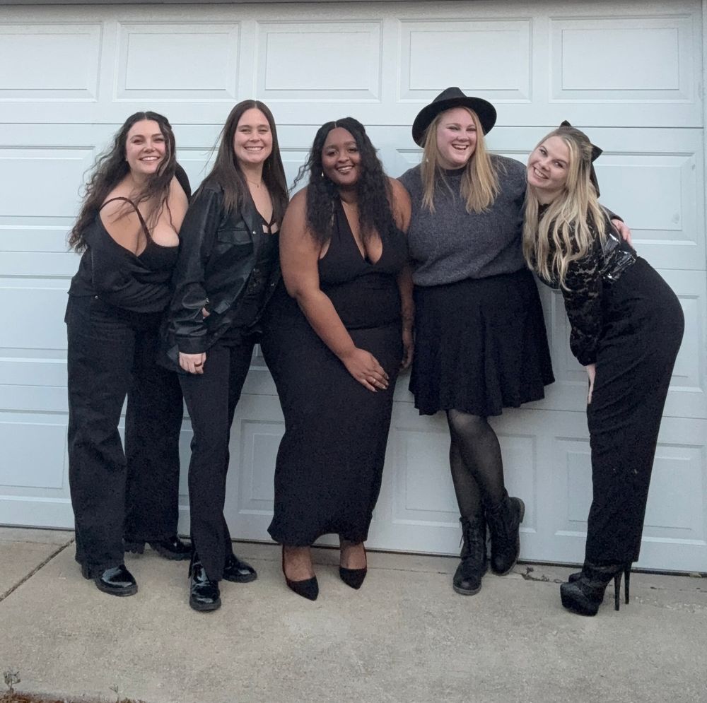my friends and me all wearing black standing in front of a garage, there are 5 of us standing in a row
