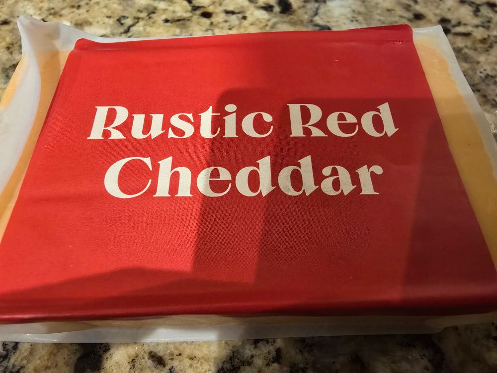 A block of Rustic Red Cheddar cheese 