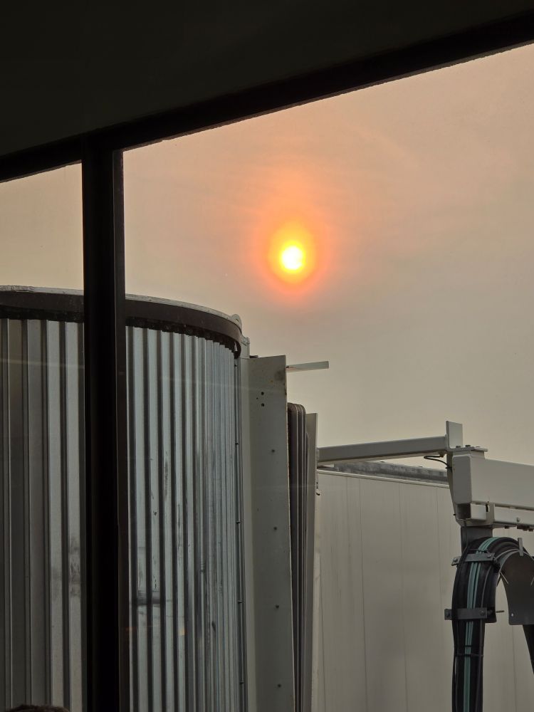 Hazy sunrise over the jetway at Logan Airport 