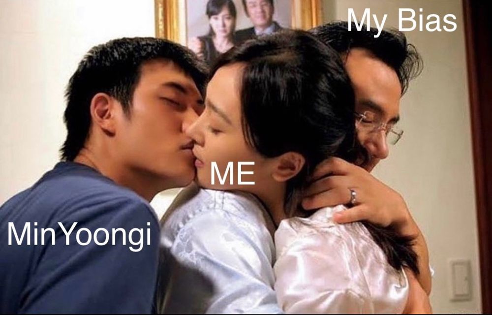 A woman being hugged by a man is being kissed by another man behind him