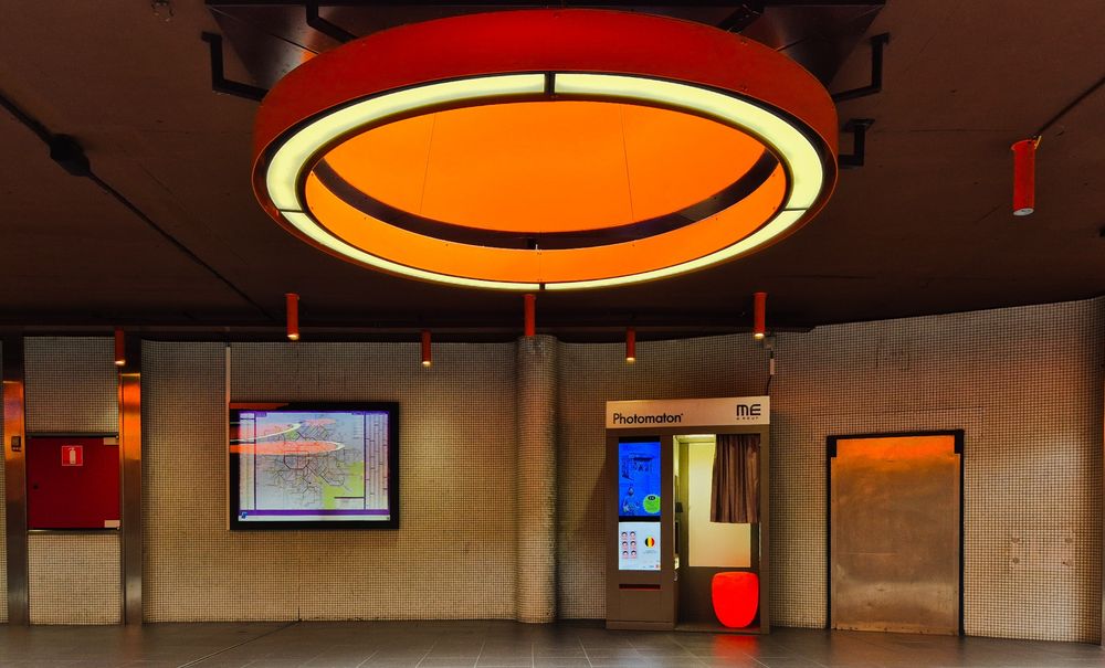 Orange stool in photo booth matches the decor