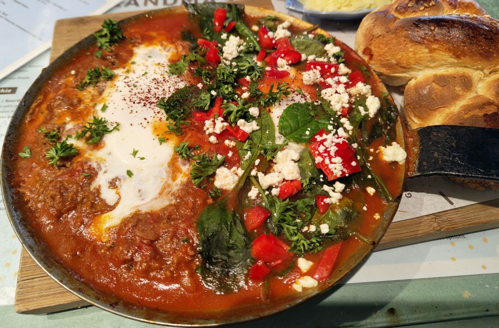 Yummy picture of mixed Shakshuka in tomato sauce with super fresh and crunchy bread.