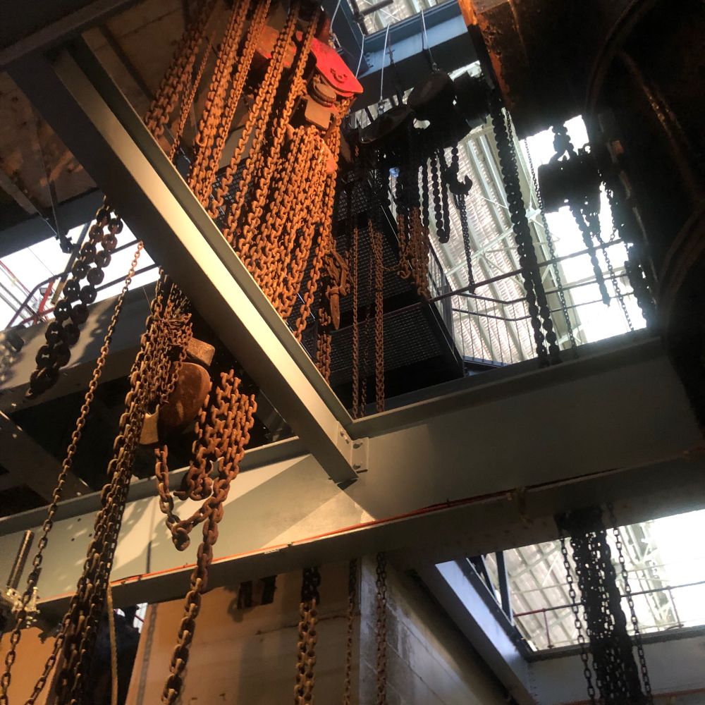 Gantries and skeins of rusty chains hung from girders