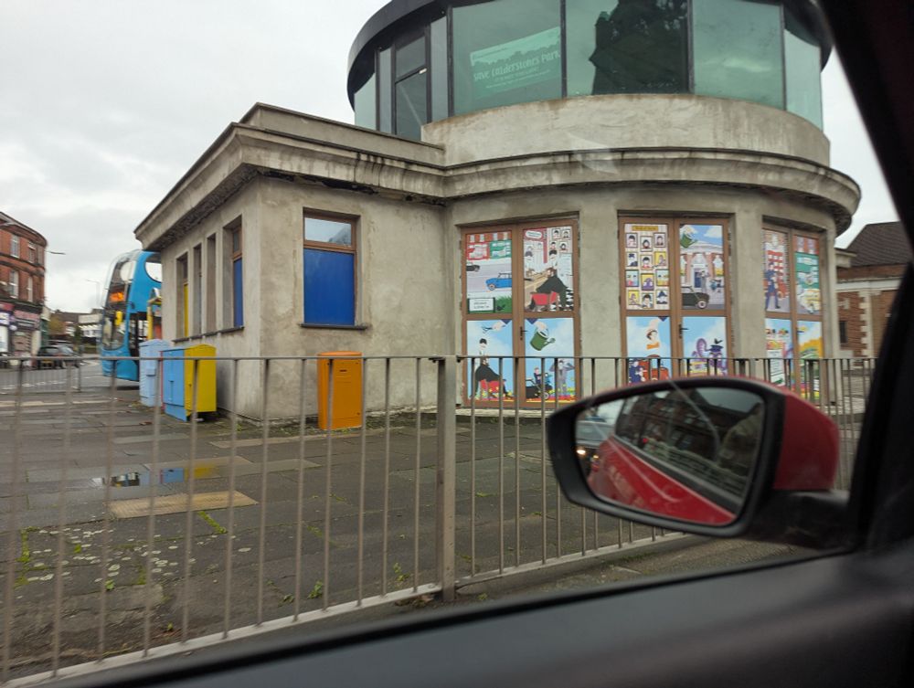 Bus shelter with murals, turned into a café.