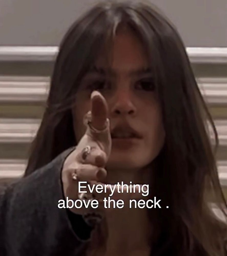 Everything above the neck written over Sofia pointing a finger gun to the audience. 