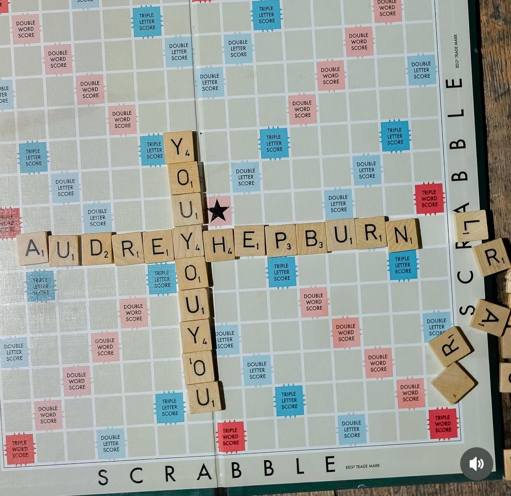 A scrabble board that is set to spell out Audrey Hepburn and You you you. 