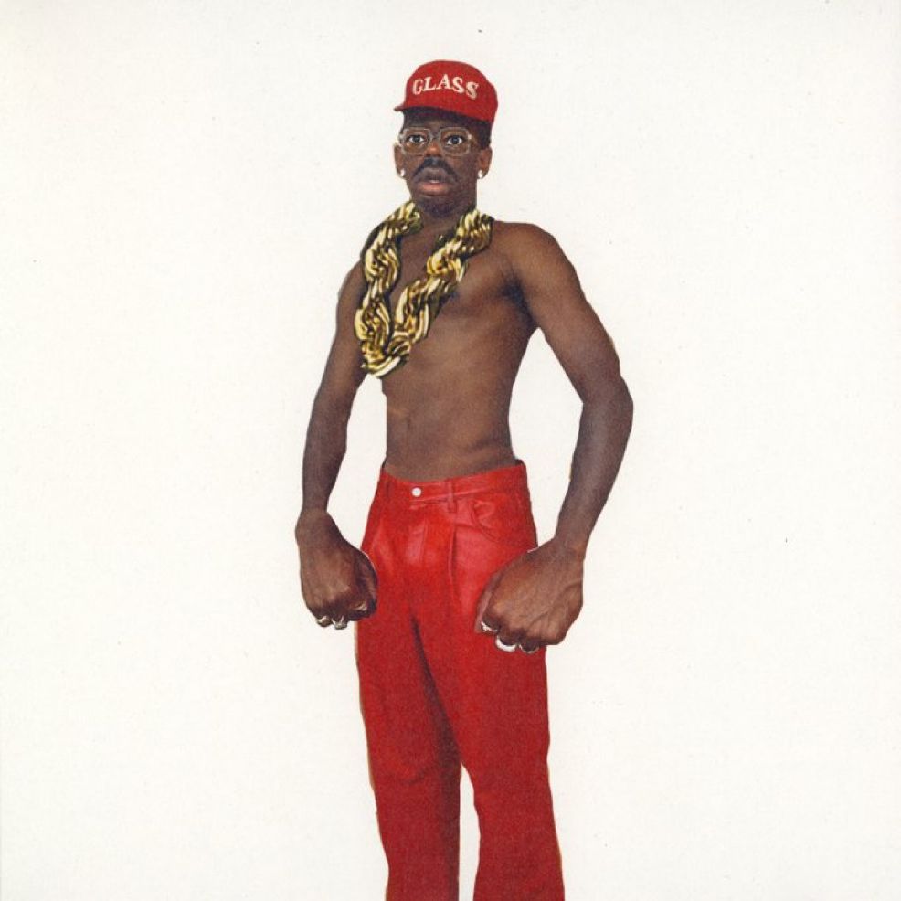 A graphic representation of Tyler with red leather pants and no shirt on. He wears a chain and a hat that says glass. 