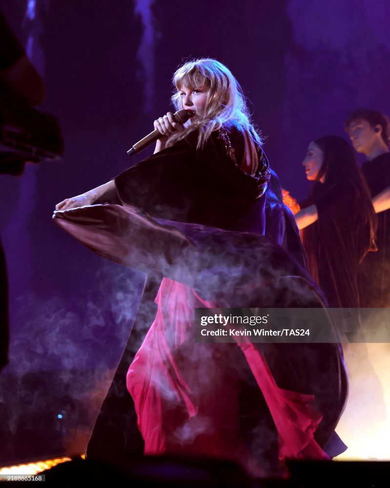 Taylor performing Willow with the Ruby red dress under the willow velvet cape. 