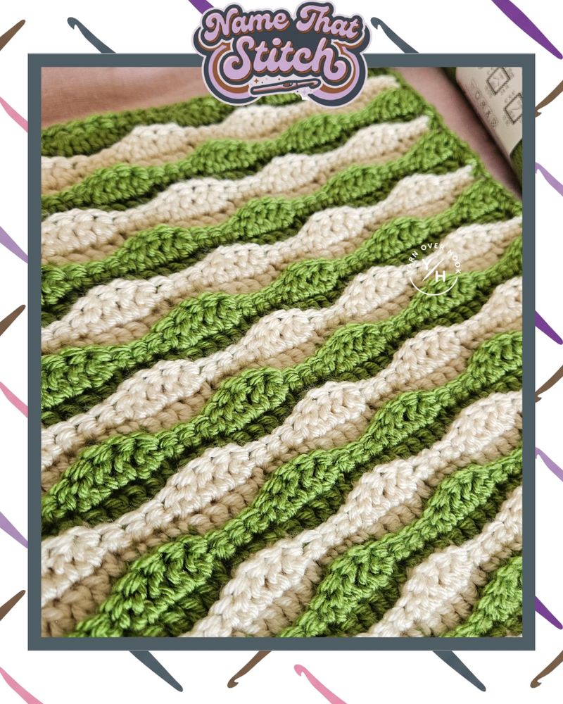 Close-up of a crocheted swatch with raised, wavy stitch rows in alternating green and cream yarn, featured as part of the Name That Stitch daily crochet puzzle.