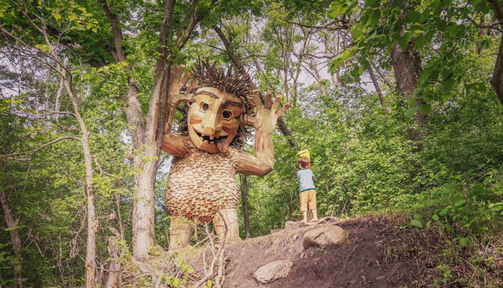 He makes giant trolls out of trash, hides them in woods for people to find