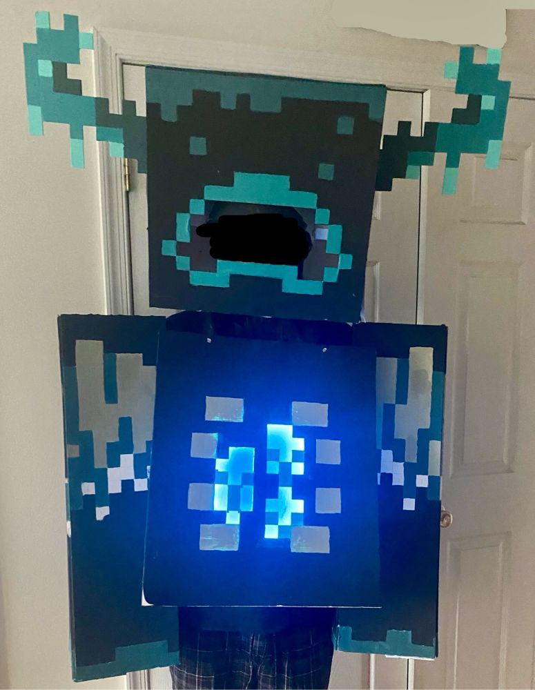 me wearing a costume of the warden from minecraft. painted to have the texture from barebones resource pack.