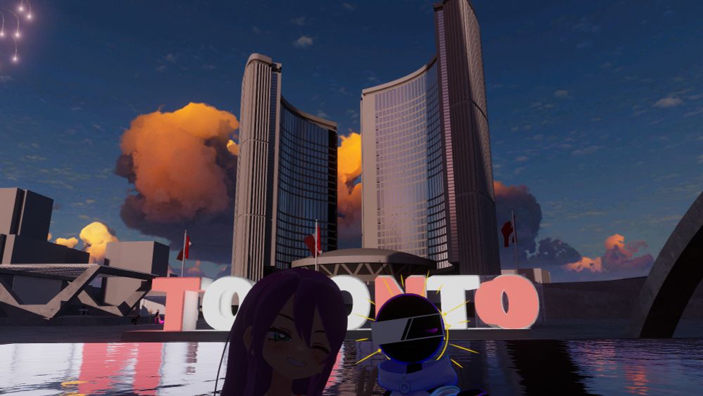A replica of Toronto City hall in VRChat. Swiftp and Jaime are posing in front of it, close to the camera, with the city hall, Toronto sign, and reflecting pool in the background.