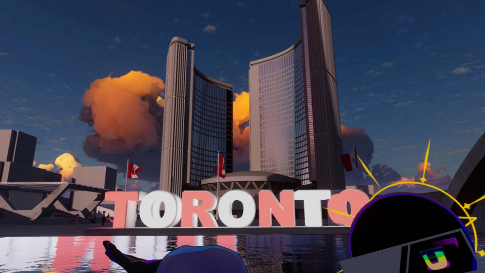 A replica of Toronto City hall in VRChat. Jaime is posing in front of it, close to the camera, with the city hall, Toronto sign, and reflecting pool in the background.