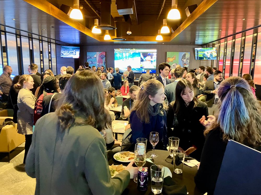 A large room at a bar full of people