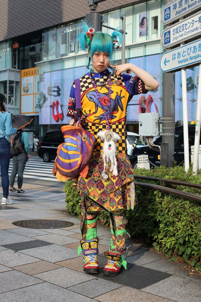 A young woman in Harajuku wearing colorful alternative style clothing.