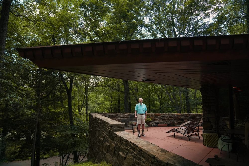 A man standing on what appears to be a balcony of his home. 